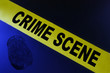 Yellow crime scene tape on blue background with fingerprint