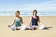 Couple meditating at the beach