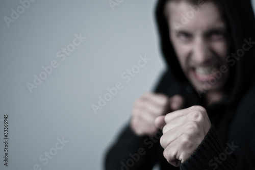 Photo: aggressive young man in boxing position aggressive young man in boxing position