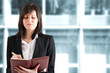 Businesswoman writing on her agenda