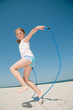Happy summer vacation - girl playing on the beach