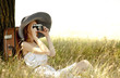 Redhead girl sitting near tree with vintage camera.