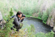 Man photographing on the top of taiga forest. Man photographing on the top of taiga forest.