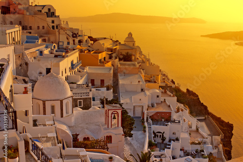Photo: Sunset at Santorini island , Greek church with a cross Sunset at Santorini island , Greek church with a cross