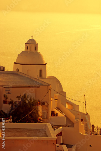 Photo: Sunset at Santorini island , Greek church with a cross Sunset at Santorini island , Greek church with a cross