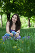 Photo: Young smiling woman sitting in the grass Young smiling woman sitting in the grass
