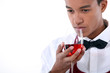 Young waiter smelling a glass of rose wine