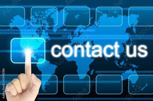 Photo: hand pressing contact us button on a touch screen interface hand pressing contact us button on a touch screen interface
