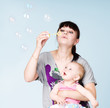 Photo: Mother and daughter blowing bubbles Mother and daughter blowing bubbles