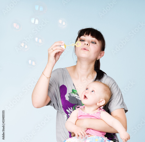 Photo: Mother and daughter blowing bubbles Mother and daughter blowing bubbles