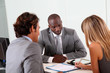 Couple meeting businessman in office Couple meeting businessman in office