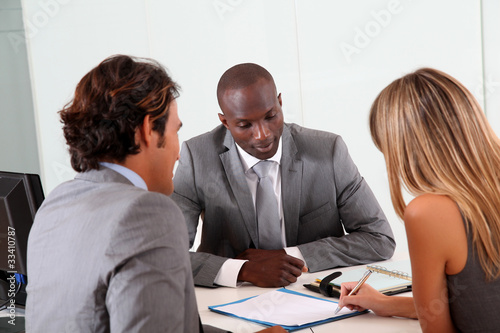 Photo: Couple meeting businessman in office Couple meeting businessman in office