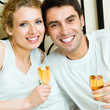 Young smiling amorous couple celebrating with champagne Young smiling amorous couple celebrating with champagne