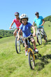 Family on a mountain bike ride in summer Family on a mountain bike ride in summer