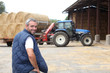 Famer stood by hay barn Famer stood by hay barn