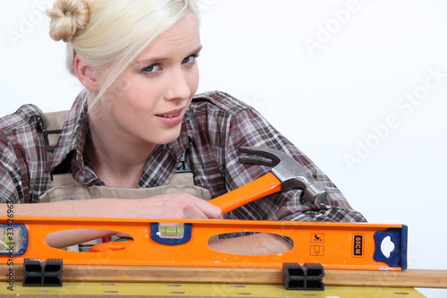 Photo: blonde holding a hammer blonde holding a hammer