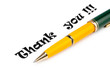 Thank you message and pen on white