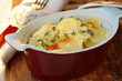Potato gratin dauphinoise in the pan on rustic background Potato gratin dauphinoise in the pan on rustic background