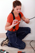 handywoman using stripping pliers on a wire