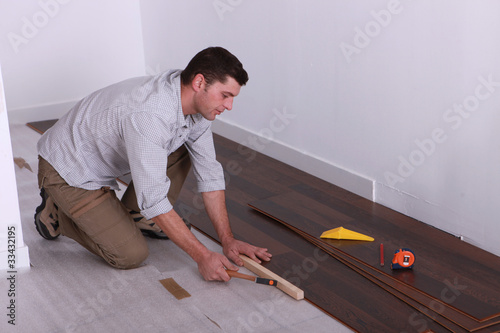 Photo: craftsman putting a wood flooring craftsman putting a wood flooring