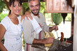 Couple cooking sausages on the barbecue