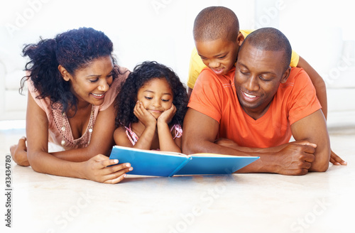 Photo: African American family reading book together African American family reading book together