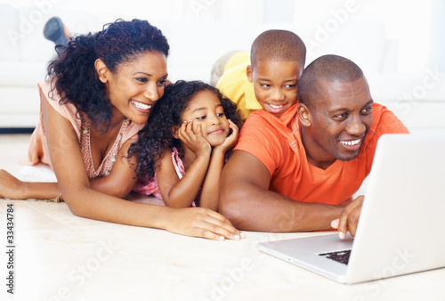 Photo: African American family using laptop African American family using laptop