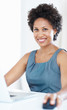 Confident business woman working on laptop
