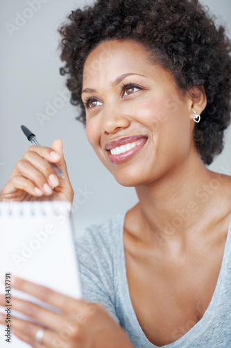 Photo: Charming woman writing in notepad Charming woman writing in notepad