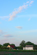 Evening clouds over the house in the village