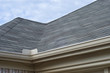 Rain Gutters Splash Guard on Roof against blue sky
