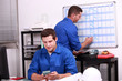 Two electricians working in back office