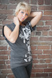 Photo: Beautiful blond against brick wall portrait Beautiful blond against brick wall portrait