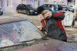 Hooligan smashing windshield