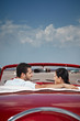 Photo: man and beautiful woman hugging in cabriolet car man and beautiful woman hugging in cabriolet car