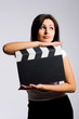 young woman holding a clapper