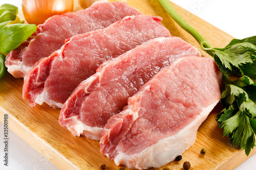 Photo: Raw pork on cutting board and vegetables Raw pork on cutting board and vegetables