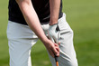 man golfs