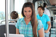 Young woman working on a laptop on a tram