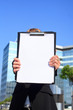 businesswoman holding a blank document