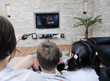 family wathching flat tv at modern home indoor