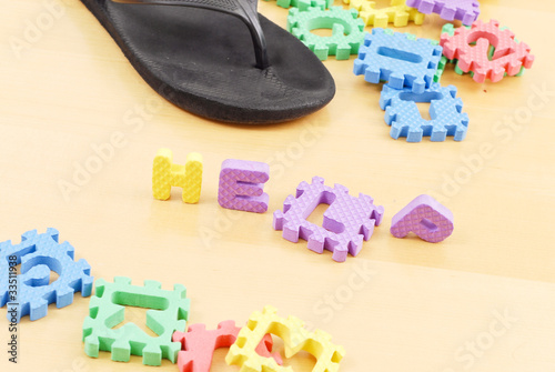 Photo: Letters Spelling the Word Help on Floor with Mommys Slipper Letters Spelling the Word Help on Floor with Mommys Slipper