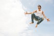 Man jumping against blue sky