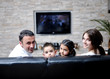 family wathching flat tv at modern home indoor family wathching flat tv at modern home indoor