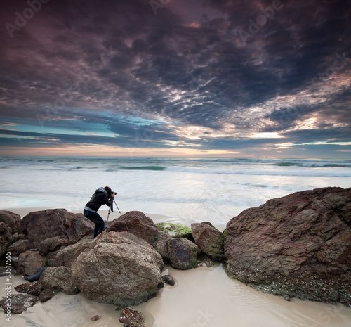 Photo: woman photographer takes photo of the seascape woman photographer takes photo of the seascape