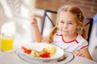 toddler girl have a breakfast outdoor