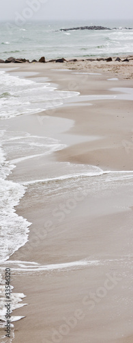 Foto: Sandstrand mit Wellen Sandstrand mit Wellen
