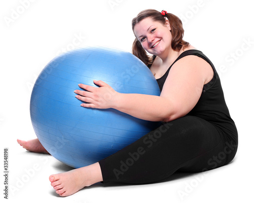 Foto: Happy overweight young woman with blue ball Happy overweight young woman with blue ball