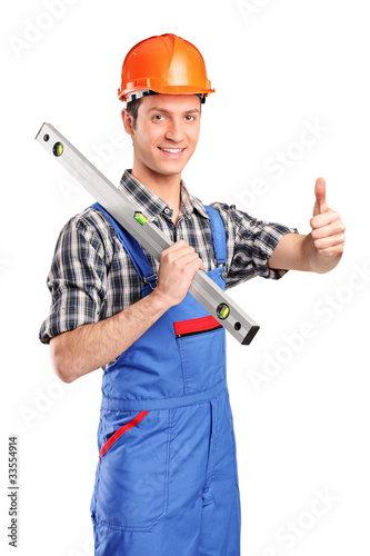 Foto: Worker holding a construction bubble level and giving thumb up Worker holding a construction bubble level and giving thumb up