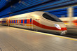Modern high speed train at the railway station at night